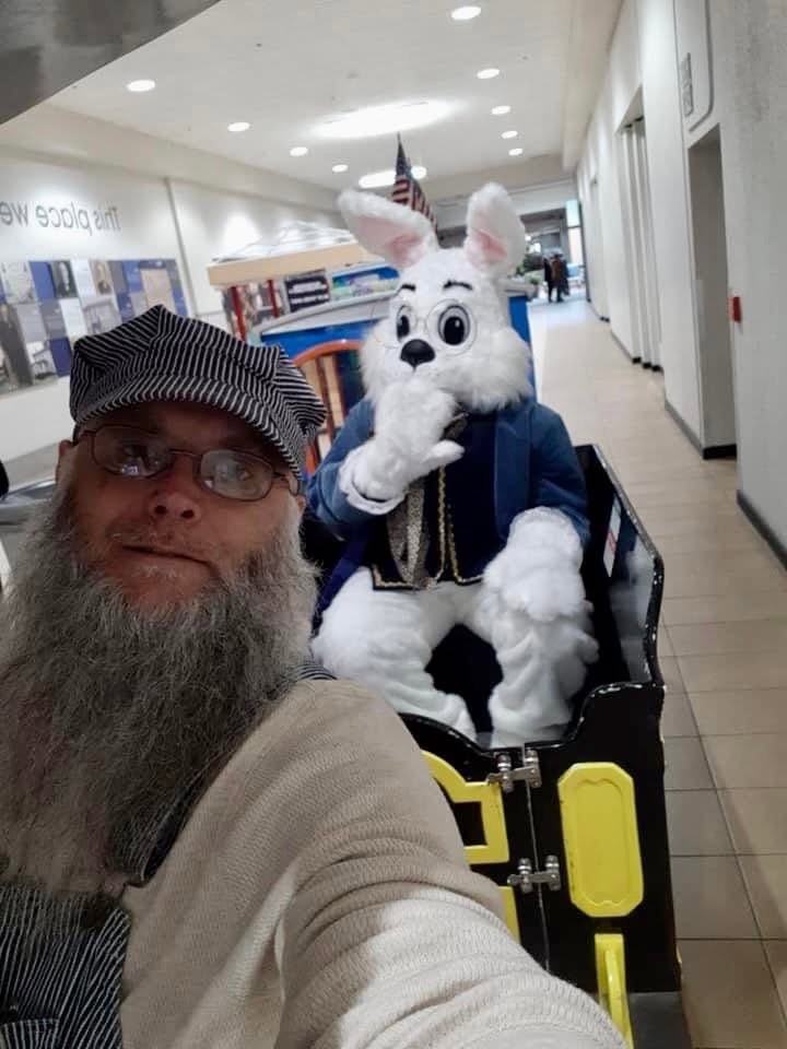 The Easter Bunny riding the All Smiles Aboard trackless train at the mall