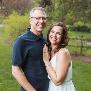Emma's parents, Brian and Denise, smiling together outdoors